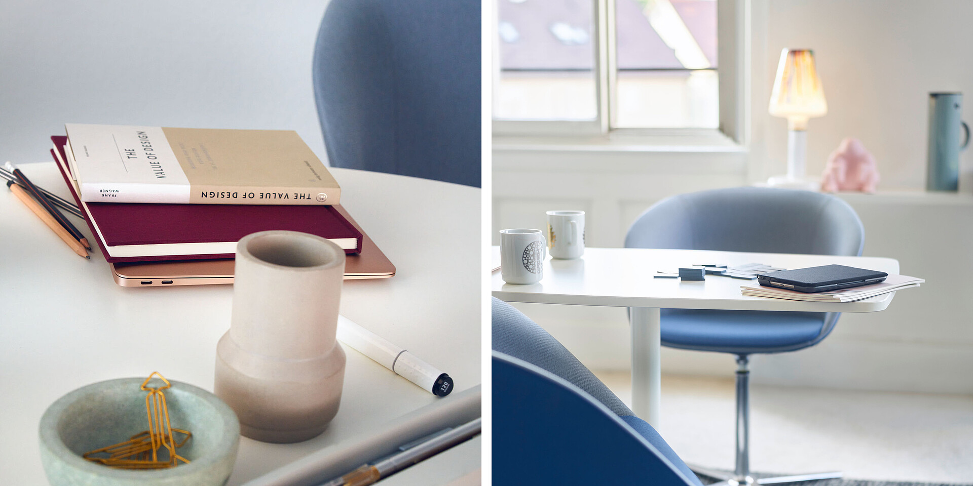 Modern workspace with blue chair, white desks, books, pen holder, and two cups in front of a window with daylight.