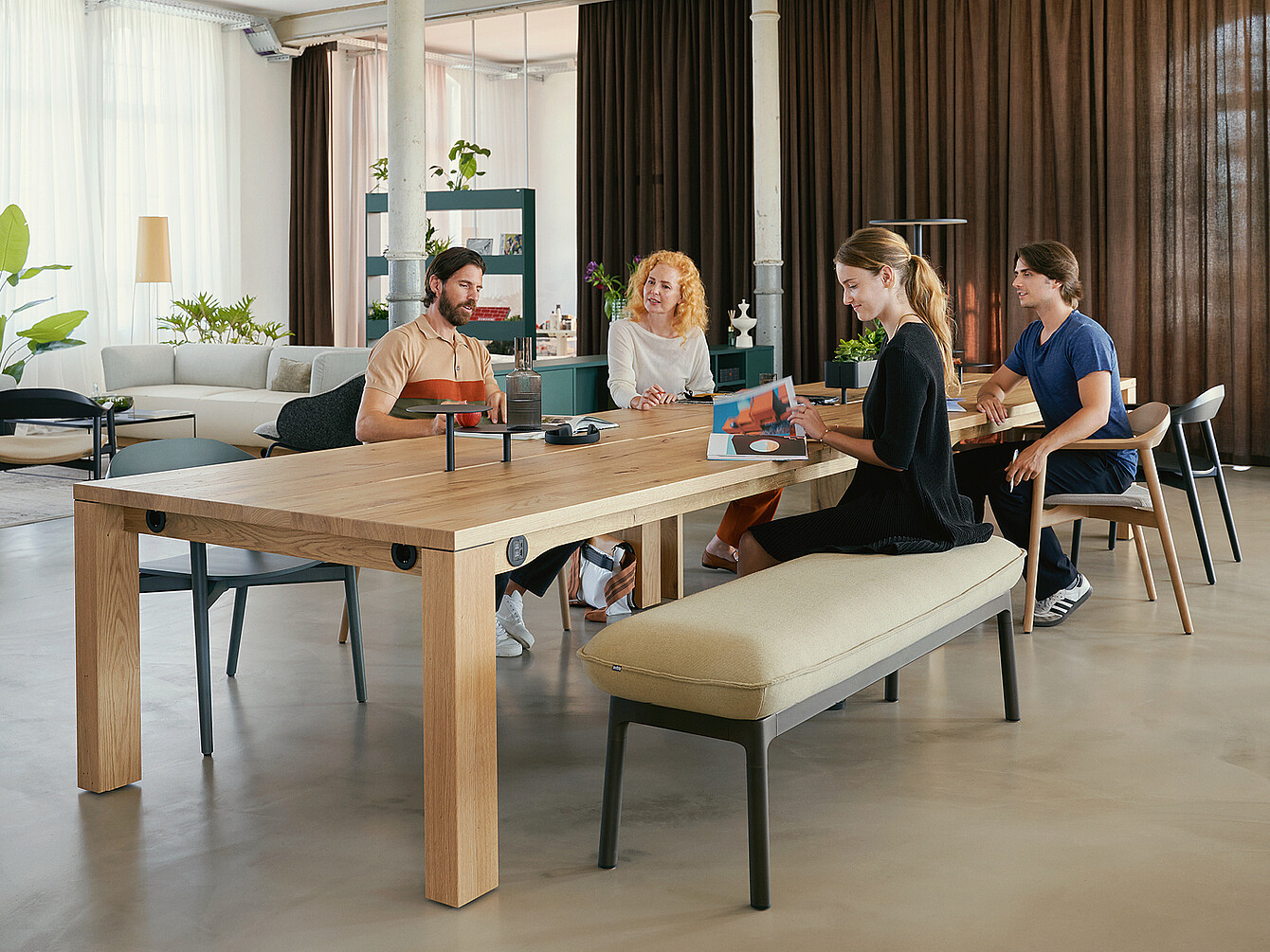 Plusieurs personnes sont assises, détendues, à se:cafe team table