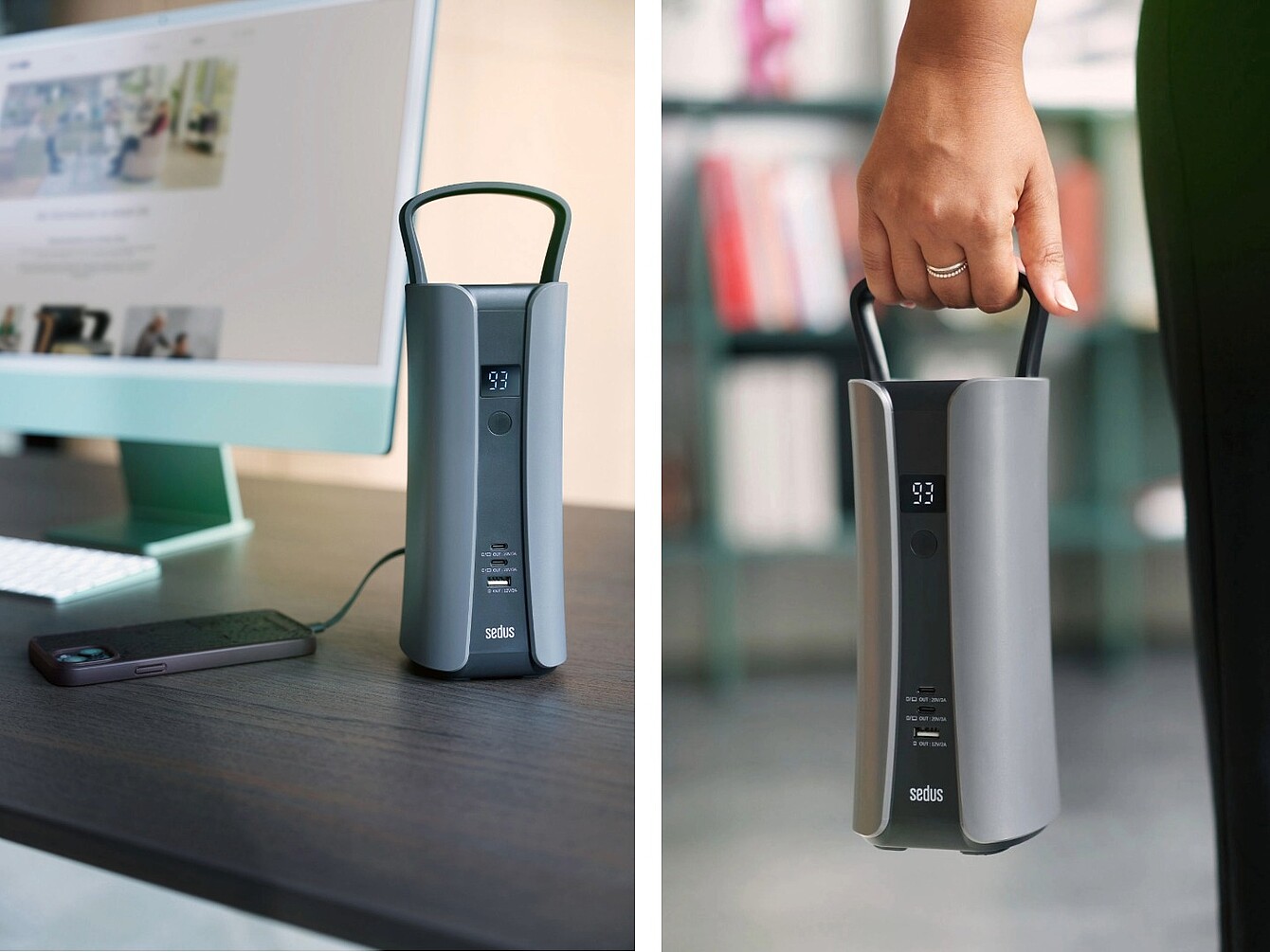 Batería portátil con asa y pantalla digital que muestra «93» sobre un escritorio, junto a un ordenador, y una mano sujetando la batería por el asa